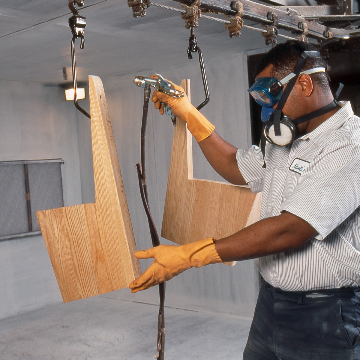 Craftsman professionally refinishing a church pew to restore its original beauty